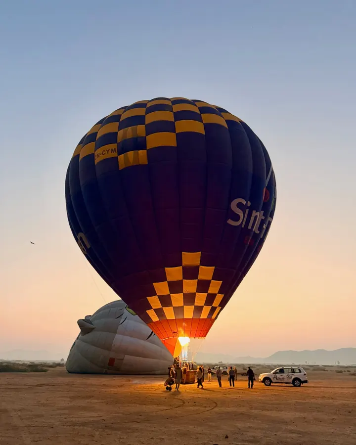 Hot air balloon lighting up at sunrise