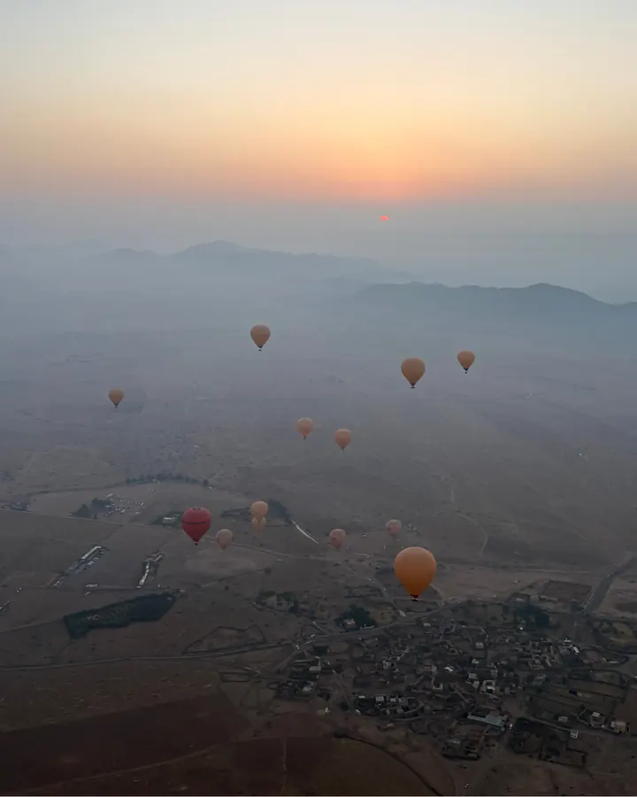 Hot air balloons over the Atlas foothills at dawn