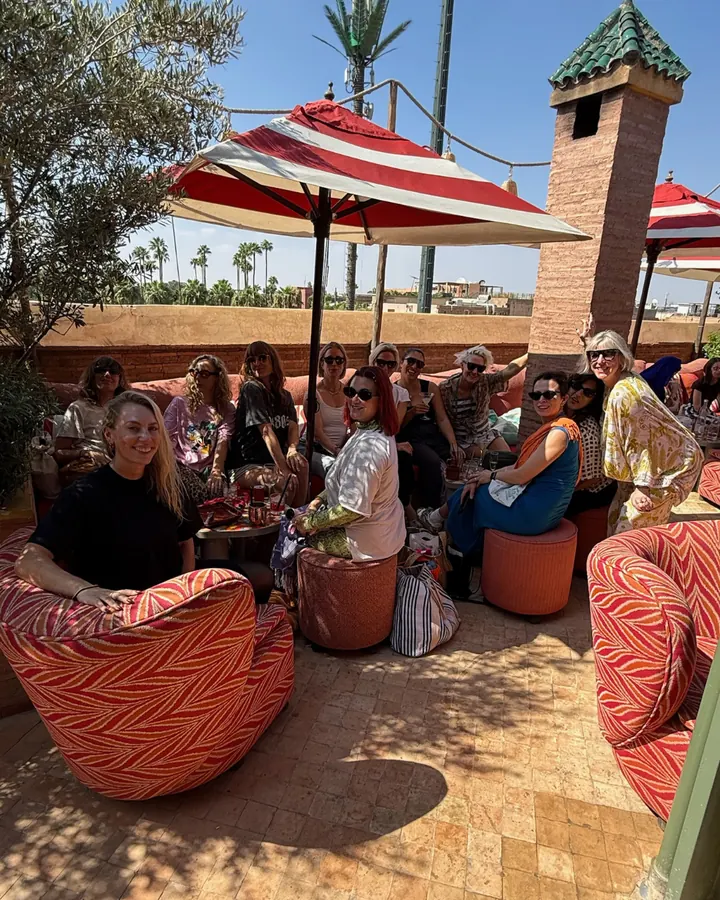 Guests relaxing on the terrace under striped parasols